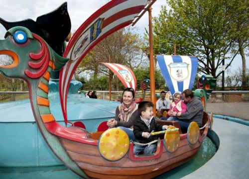 Im Schiff der Wikingerbootsfahrt sitzen vier Gäste: Ein Mann, eine Frau, Ein Junge und ein Mädchen.