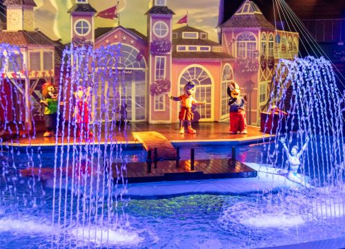 4 HANSA-PARK-Maskottchen stehen auf der Bühne, im Vordergrund ist Wasser zu sehen