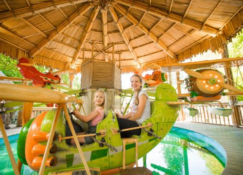 Ein Kind ist vorne und das andere hinten im Flugzeug in der Attraktion Dr. Livingstones Safariflug.