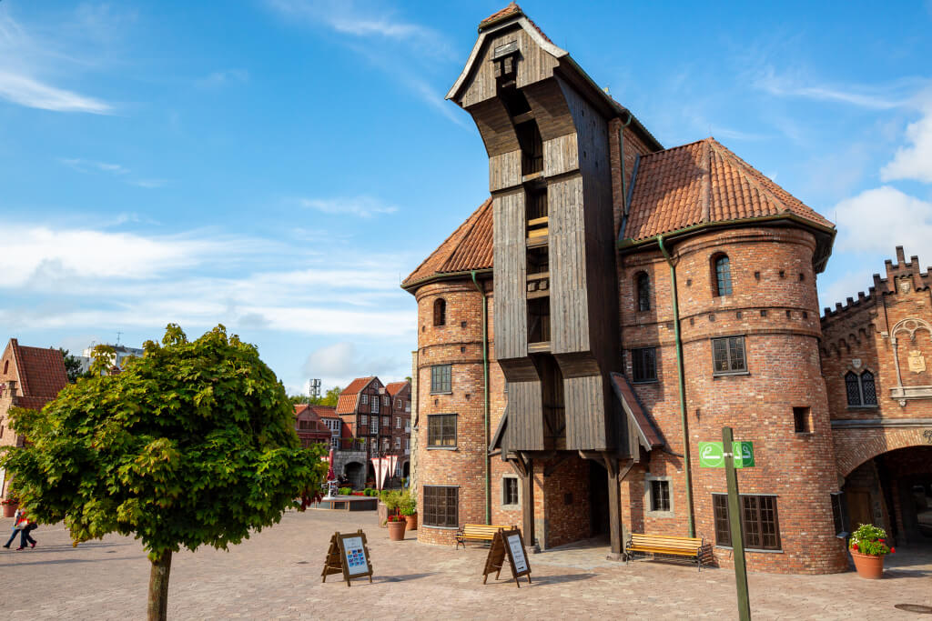 Das Krantor von Danzig von vorne. Davor sind Schilder und ein Schild für eine Raucherinsel.