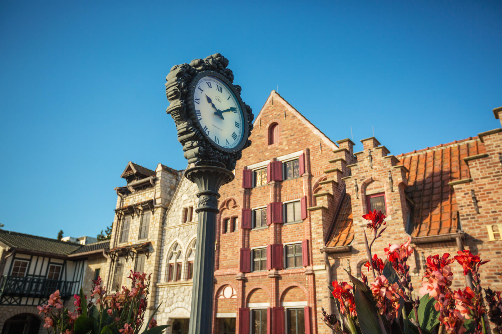 Im Vordergrund befindet eine verzierte Uhr. Im Hintergrund befinden sich hanseatische Arkaden.
